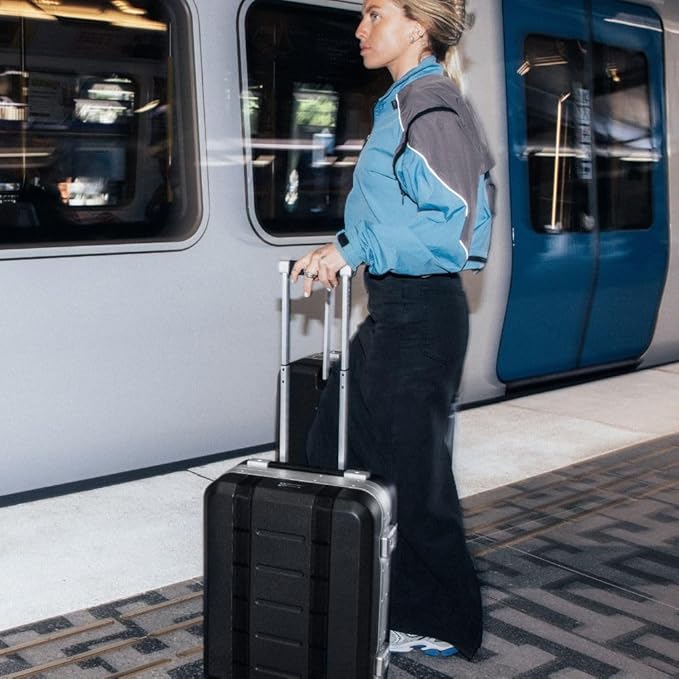 D_b_ Ramverk Pro Carry-On 21 Inch Hardside Luggage Extra Protection Aluminum Frame, Silent 360 Spinner Wheels, TSA Lock, Interior Laptop Compartment and Two Zipper Dividers - Silver Frame/Black