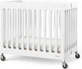 Foundations Boutique Folding Mini Baby Crib - Compact, Portable, Wooden Hotel Crib, Foldable Mini Crib for Baby & Toddlers - Includes 3" Foam Mattress, White