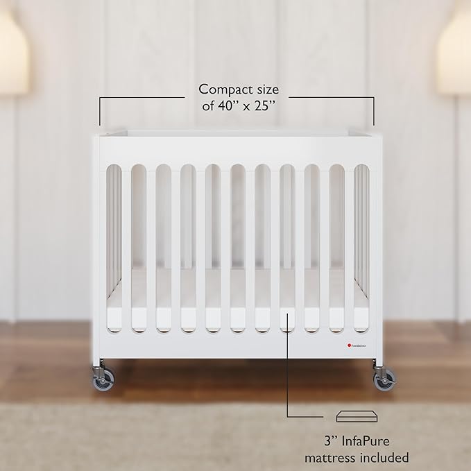 Foundations Boutique Folding Mini Baby Crib - Compact, Portable, Wooden Hotel Crib, Foldable Mini Crib for Baby & Toddlers - Includes 3" Foam Mattress, White