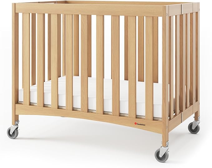 Foundations Travel Sleeper Wood Compact Folding Crib with 2” InfaPure Foam Crib Mattress and Commercial Grade Casters for Hotels, Natural