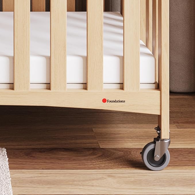 Foundations Travel Sleeper Wood Compact Folding Crib with 2” InfaPure Foam Crib Mattress and Commercial Grade Casters for Hotels, Natural