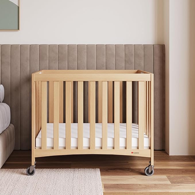 Foundations Travel Sleeper Wood Compact Folding Crib with 2” InfaPure Foam Crib Mattress and Commercial Grade Casters for Hotels, Natural